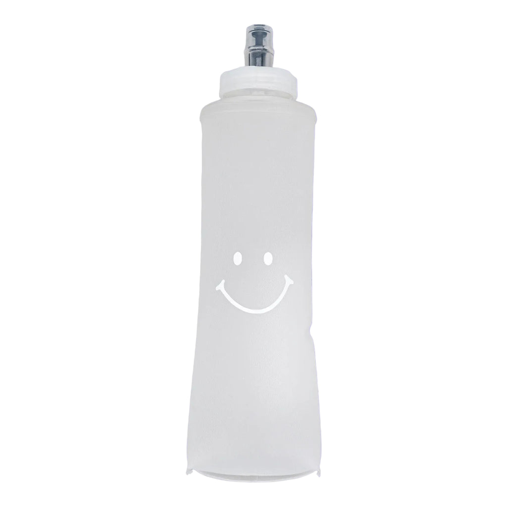 White bottle with a smiley face on a purple background