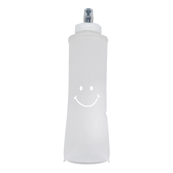 White bottle with a smiley face on a purple background