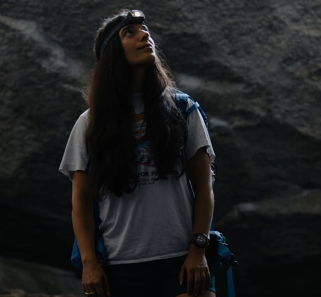 Woman rock climbing wearing a Coros Nomad Watch. 
