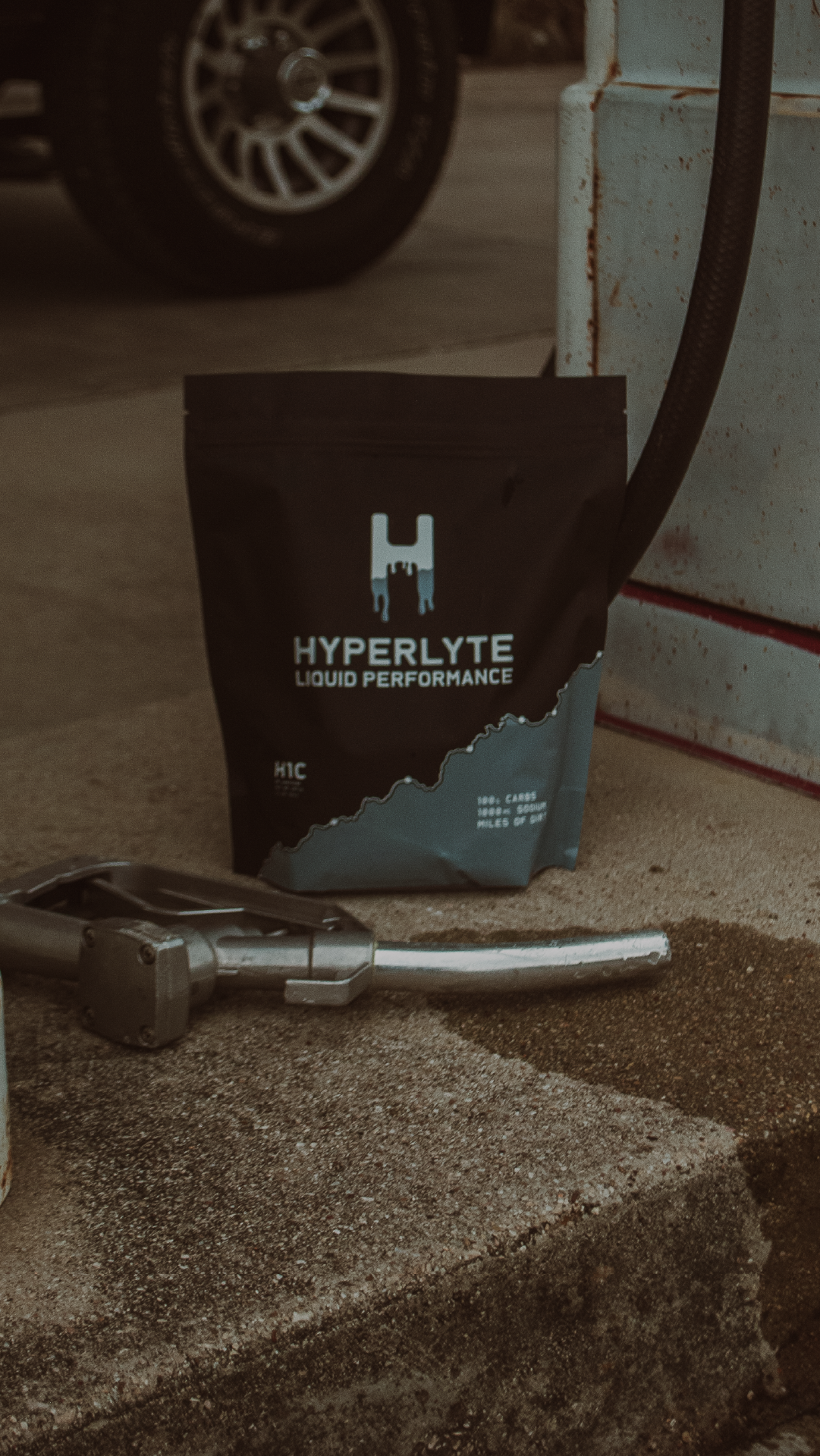 Hyperlyte H1C on a concrete surface with a car tire in the background